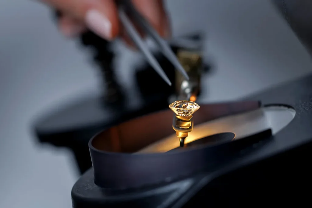 Diamond under inspection with a jeweller loupe